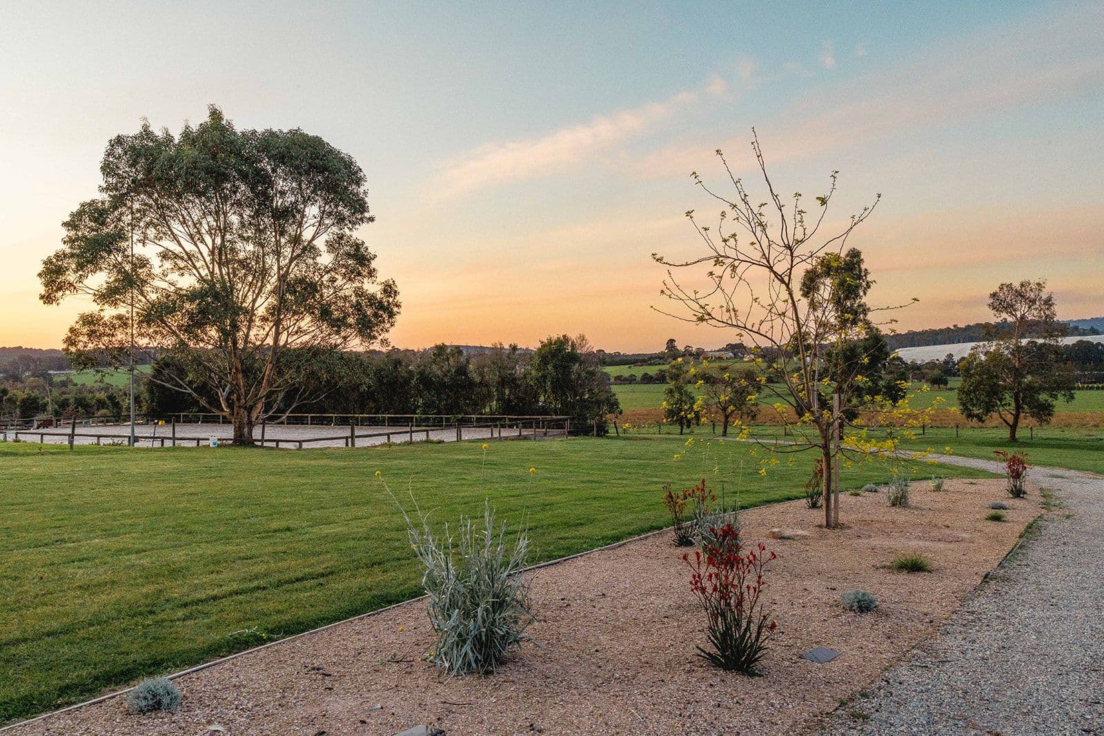 The memorial garden at dusk with plaques set in the lawn