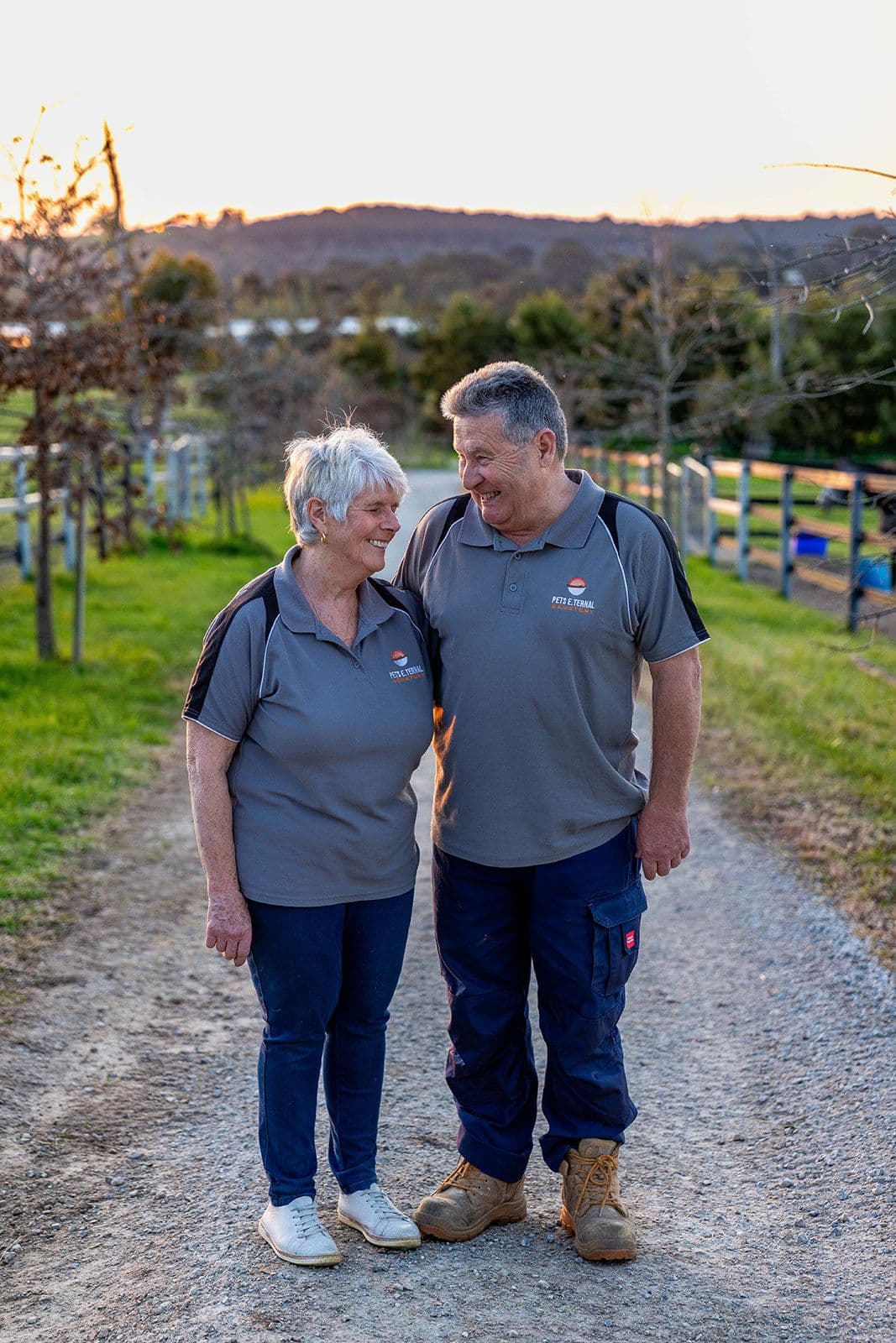 Terry and Karen walking along a tree-lined lane